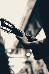 Close-up of man playing guitar