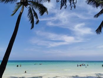 People on beach against sky