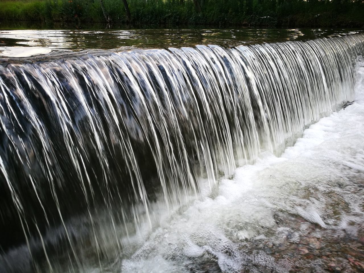 CLOSE-UP OF WATER FLOWING ON WOOD