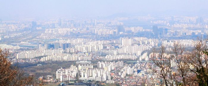 High angle view of city buildings against sky