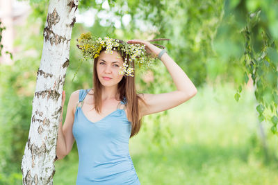 Pretty young woman with a flower wreath on her head