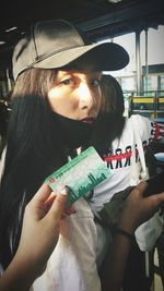 Portrait of woman holding hat