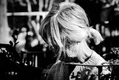 Rear view of woman looking up outdoors