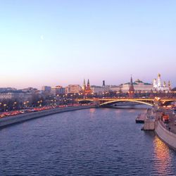 Bridge over river with cityscape in background