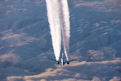 High angle view of airplane flying in sky