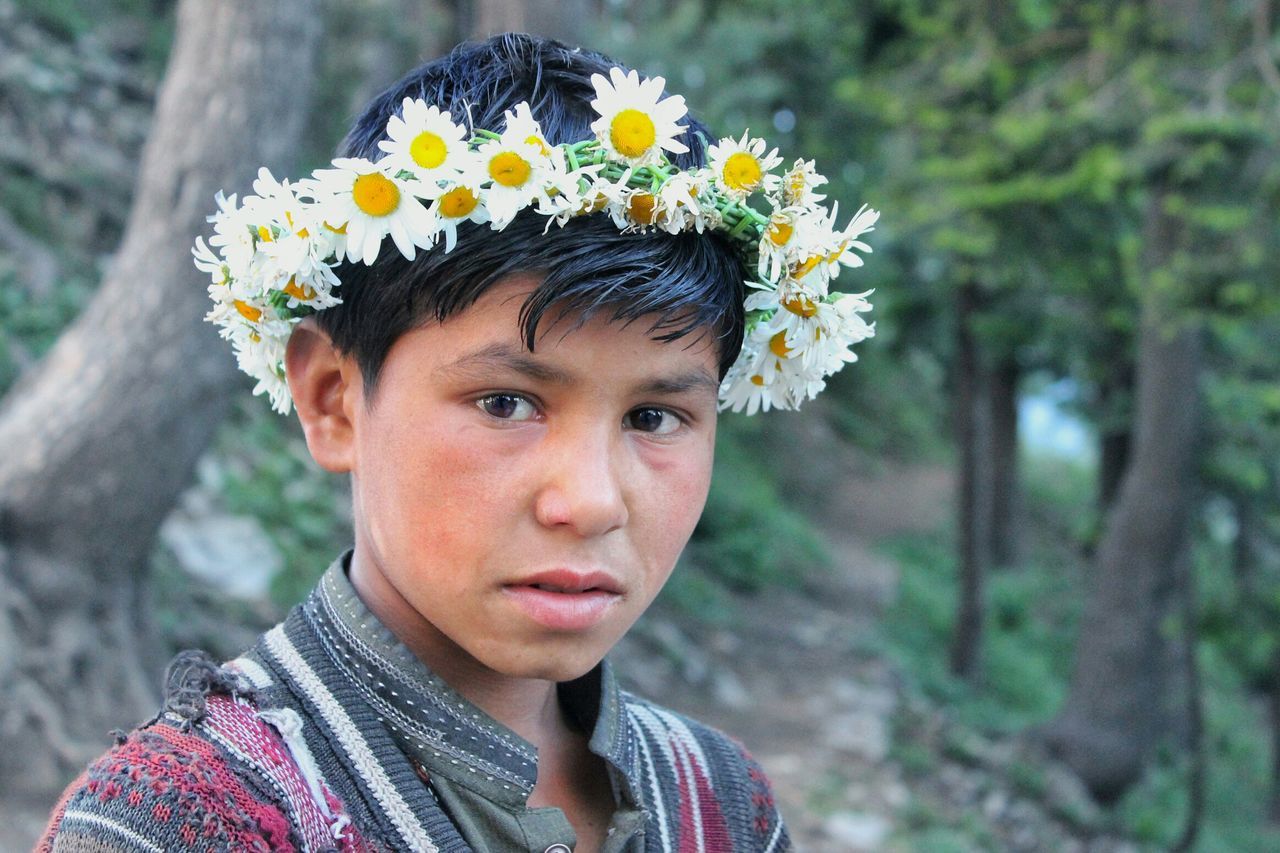 flower, real people, one person, childhood, focus on foreground, elementary age, headshot, lifestyles, leisure activity, outdoors, front view, day, close-up, boys, nature, portrait, young adult