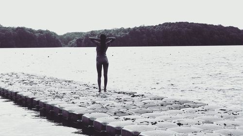 Woman in lake against clear sky