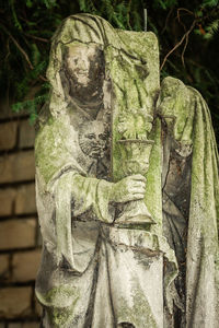 Close-up of angel statue against plants