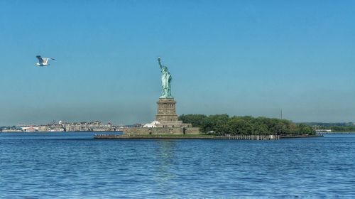 Statue of liberty with city in background