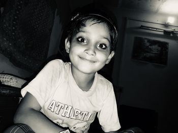 Portrait of a smiling girl sitting at home