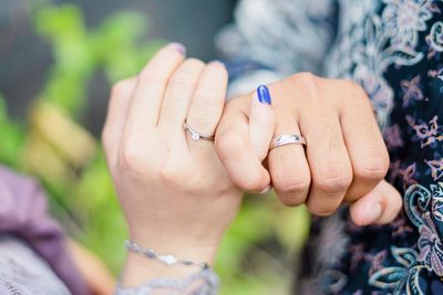 Midsection of woman holding hands