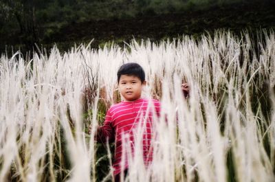 Portrait of cute boy standing on land