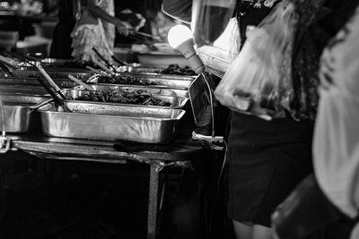 Midsection of people standing at market stall