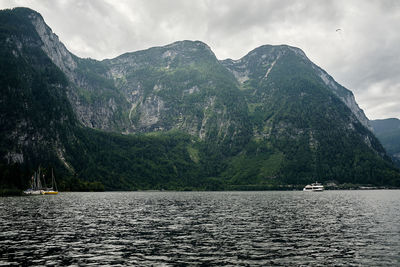 Scenic view of sea and mountains against sky