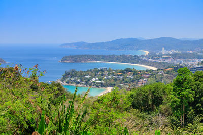 Scenic view of sea by city against sky