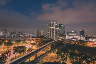 High angle view of city lit up at night