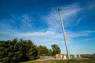 Low angle view of windmill against blue sky