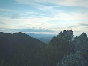 Scenic view of mountains against cloudy sky