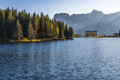 Scenic view of lake by trees against sky