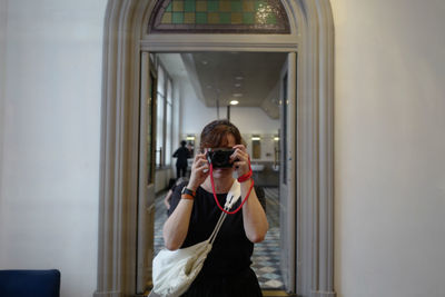 Portrait of woman photographing