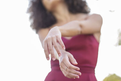 From below of unrecognizable african american female dancer moving gracefully while performing in nature at daytime