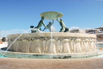 Statue of fountain against clear blue sky