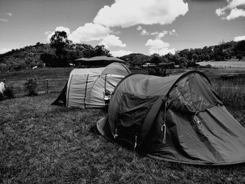 Tents on field against sky