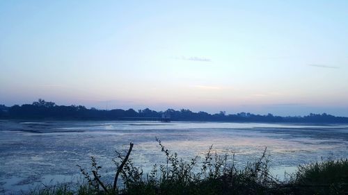 Scenic view of lake against sky during sunset