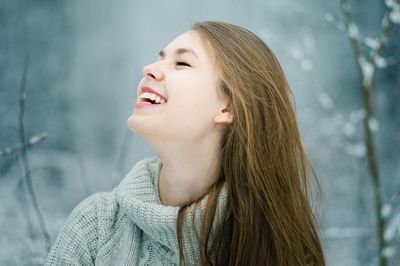 Close-up of smiling young woman during winter