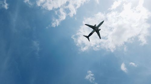 Low angle view of airplane flying in sky