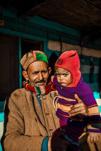 Old man with child during winter