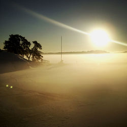 Scenic view of sunset over snowy landscape