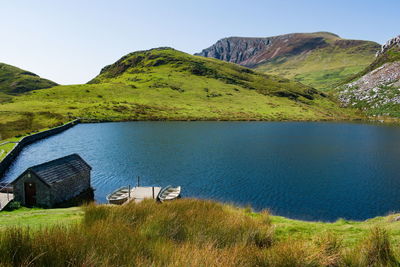 Scenic view of lake by mountain against sky