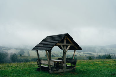 Gazebo on field against sky