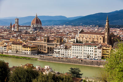 High angle view of river and buildings in city