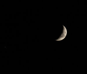 Low angle view of moon against sky at night