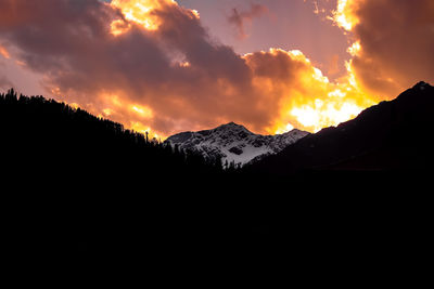 Scenic view of silhouette mountains against sky during sunset