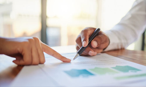 Midsection of businessman working at office