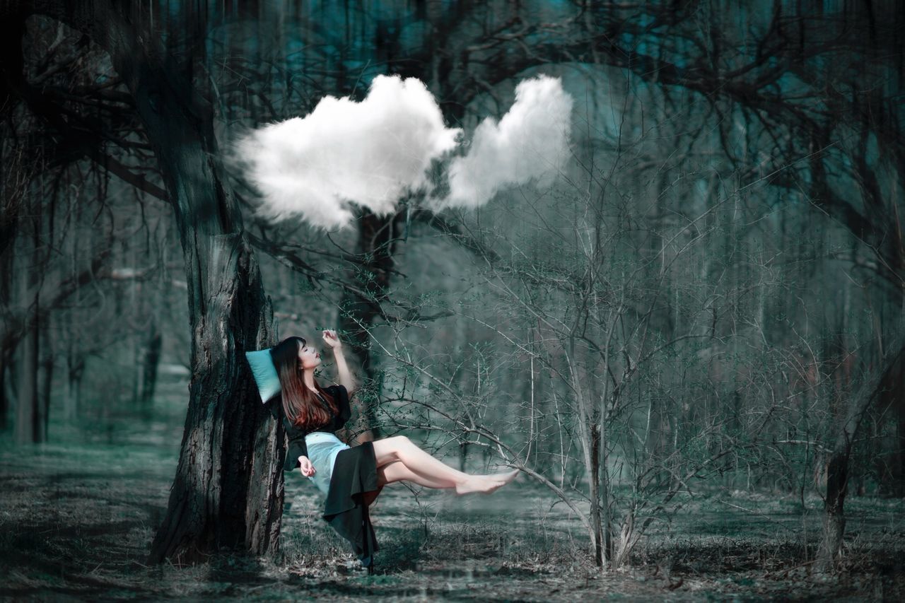 DIGITAL COMPOSITE IMAGE OF WOMAN AND MAN IN FOREST