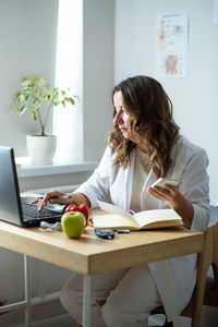 A female nutritionist endocrinologist working in her office. focused look at the camera