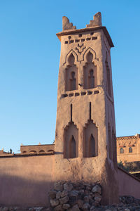 Low angle view of historical building against clear blue sky