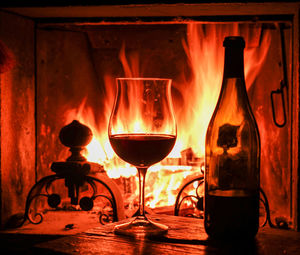 Glass of wine looking at the fireplace 