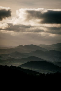 Scenic view of silhouette mountains against sky at dusk