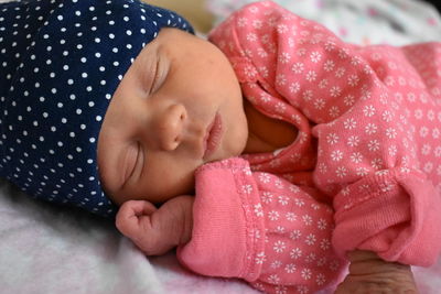 Close-up of baby sleeping on bed