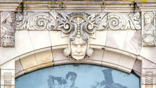 Low angle view of sculpture against building