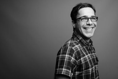 Portrait of smiling man against gray background