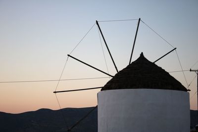 Low angle view of windmill against sky during sunset