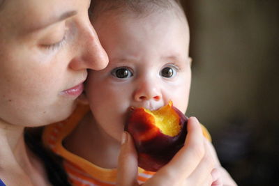 Close-up portrait of baby eating