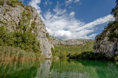 Scenic view of lake and mountains against sky