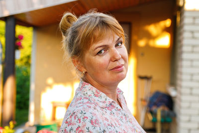 Portrait of young woman standing outdoors